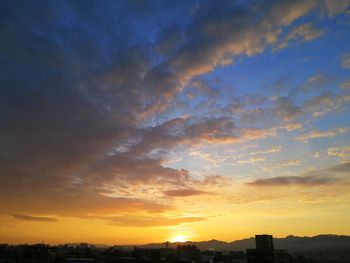 Silhouette buildings against sky during sunset