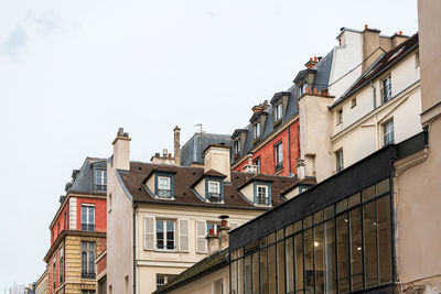 Low angle view of buildings in town against clear sky