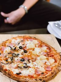 Midsection of man holding pizza