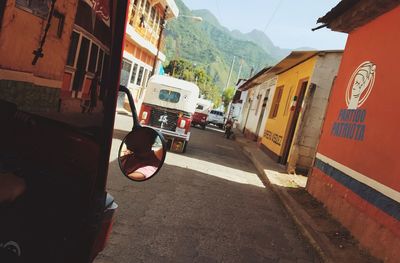 Cars on road against sky in city