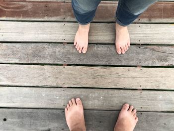 Low section of man standing on hardwood floor