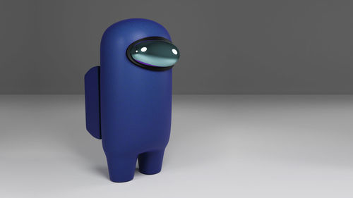 Close-up of blue toy on table against white background