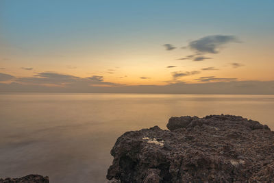 Scenic view of sea against sky at sunset