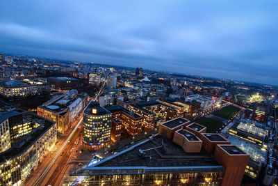 High angle view of illuminated city against sky at dusk