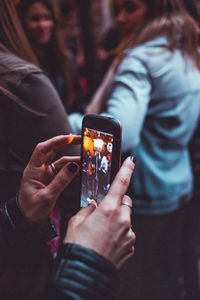 Midsection of woman using mobile phone