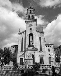 Low angle view of church against cloudy sky