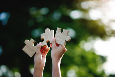 Cropped hand holding jigsaw puzzle