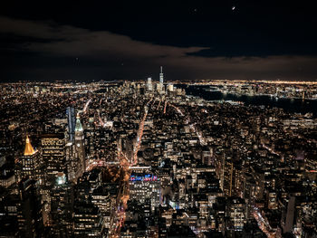 Aerial view of city lit up at night