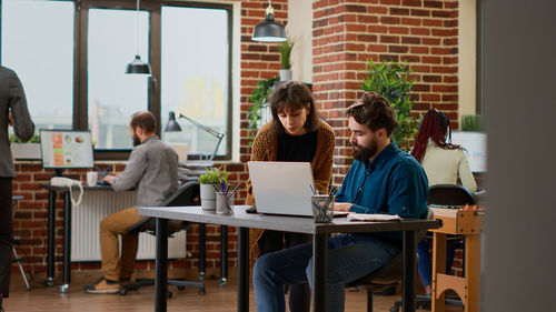 Young woman using laptop at office