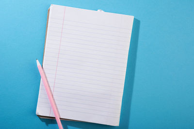 High angle view of book against blue background