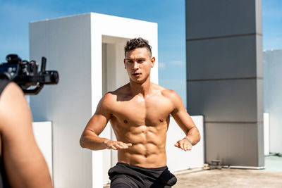 Shirtless man exercising outdoors