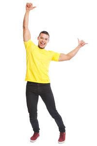 Portrait of smiling young woman standing against white background