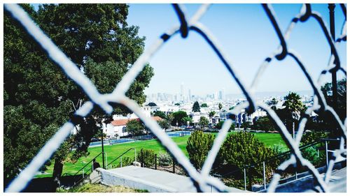 Close-up of chainlink fence against sky