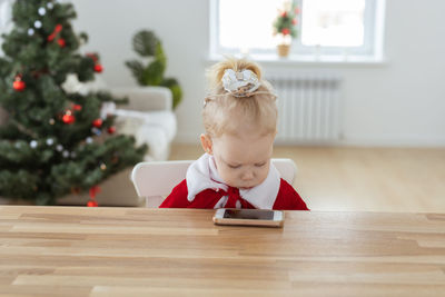 Portrait of boy sitting on table