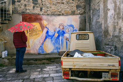 Rear view of man standing in abandoned building