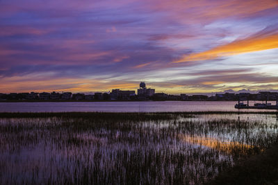 Scenic view of lake against romantic sky at sunset