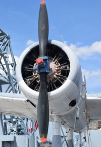 Low angle view of airplane on airport runway against sky
