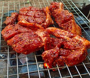 High angle view of meat on barbecue grill