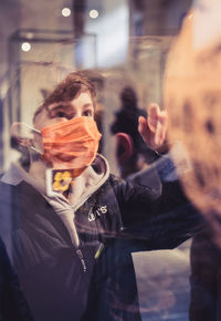 Boy through glass at the louvre museum 