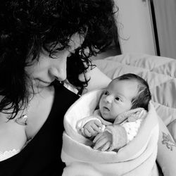 Close-up of woman with baby girl at home