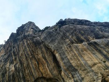 Low angle view of rock formation against sky