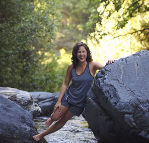 Young woman in a mountain river. she cools off after a day of hiking.