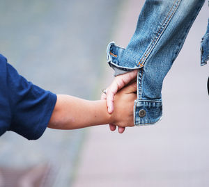 Low section of couple holding hands