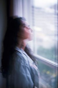 Portrait of man looking through window