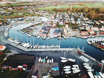 High angle view of boats moored at harbor in city