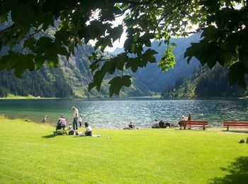 People relaxing by lake