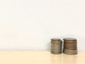 Stack of objects on table against white background