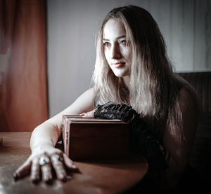 Portrait of woman sitting at home