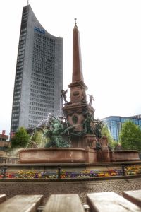 Low angle view of statue against buildings