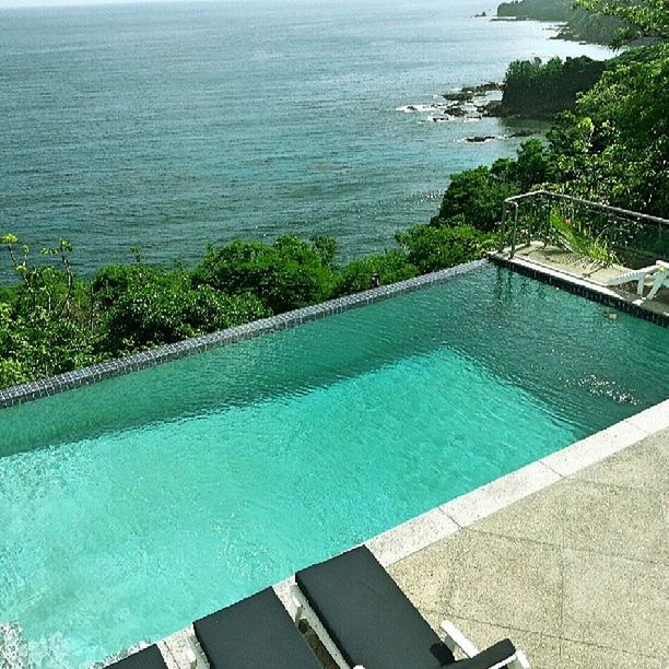 water, high angle view, sea, swimming pool, blue, turquoise colored, horizon over water, nature, day, tranquility, built structure, outdoors, tranquil scene, railing, beauty in nature, scenics, elevated view, no people, rippled, coastline