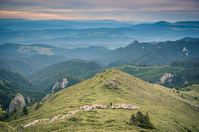 Scenic view of mountains against cloudy sky