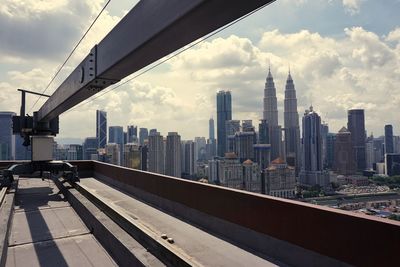 View of cityscape against cloudy sky