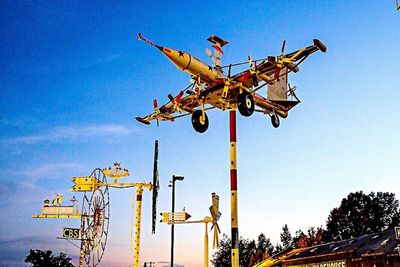 Low angle view of chain swing ride against clear blue sky