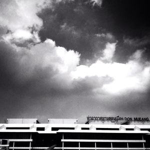 Low angle view of building against cloudy sky