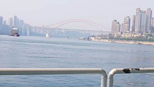 Bridge over river with city in background