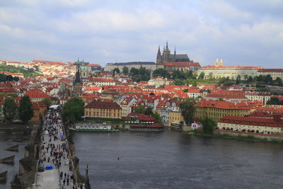 Bridge over river against buildings in city