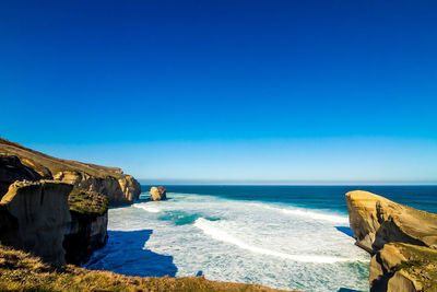 Scenic view of sea against clear blue sky