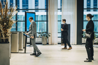 Man and woman walking in building