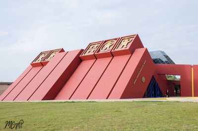 Built structure on field against sky