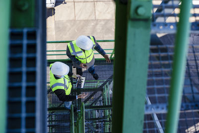 Engineers examining and having discussion at industrial plant