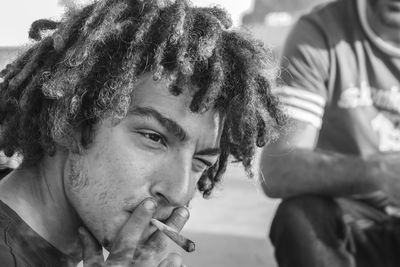 Close-up portrait of man smoking