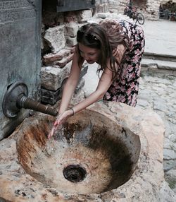 High angle view of woman washing hands in sink