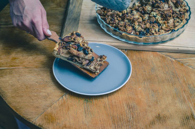 Sweet pie with apples and nuts on a blue plate