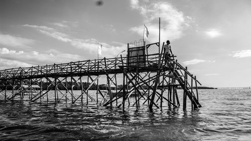 View of pier over sea against sky