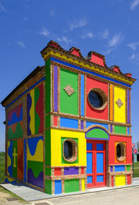 Low angle view of multi colored building against sky