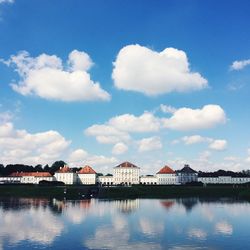 View of calm blue sea with houses in background